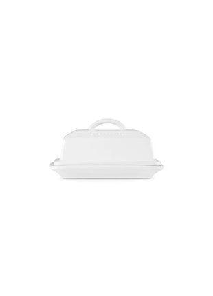 A white butter dish with a handle on top.